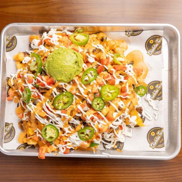 Diablos Taco's loaded fries with cheese sauce, guacamole, jalapeños, and pico de gallo.
