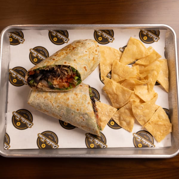 Two Diablos Tacos burritos, cut in half, with a side of tortilla chips on a metal tray.